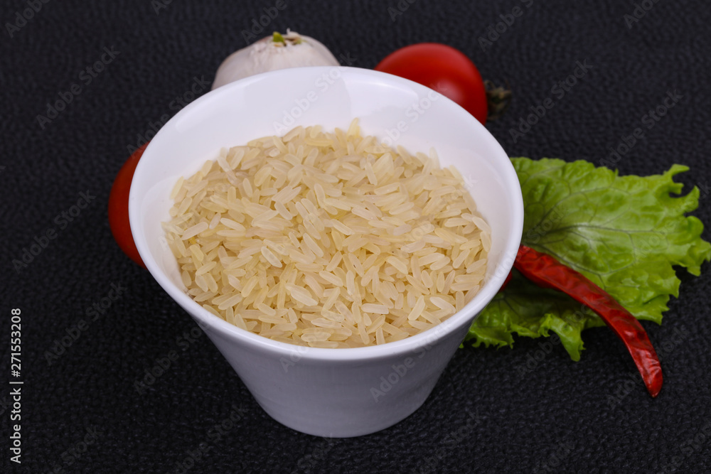 Raw uncooked rice in the bowl Raw uncooked rice in the bowl