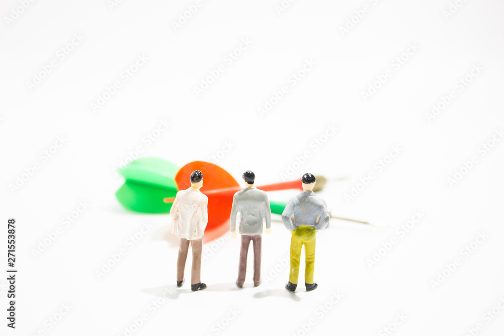 a group of miniature business people with dart isolated white background. decision concept. a group of miniature business people with dart isolated white background. decision concept.