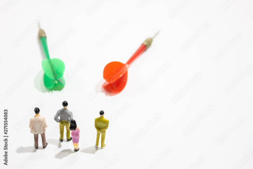 a group of miniature business people with dart isolated white background. decision concept. a group of miniature business people with dart isolated white background. decision concept.