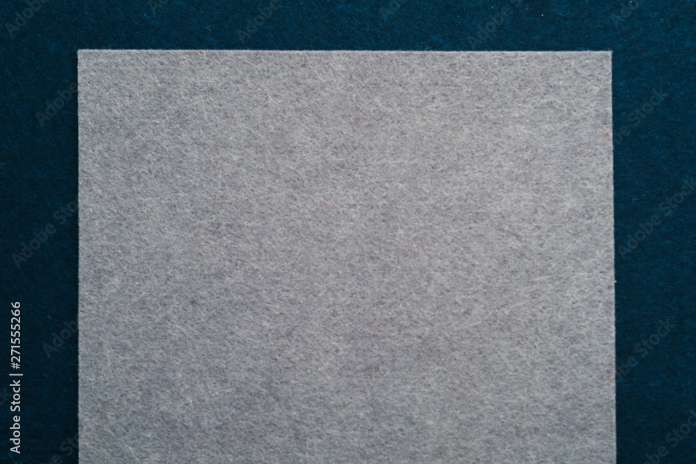 Fototapeta premium Gray felt texture layer over dark teal blue abstract art background. Geometric collage. Empty space.