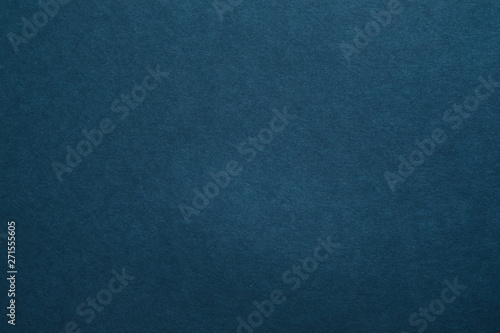 Dark blue felt texture abstract art background. Colored carton surface. Copy space.