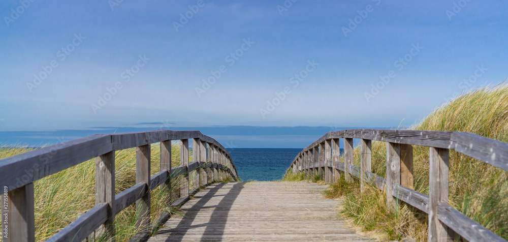 Wooden footbridge over the dunes to the beach at the German Baltic Sea coast Wooden footbridge over the dunes to the beach at the German Baltic Sea coast