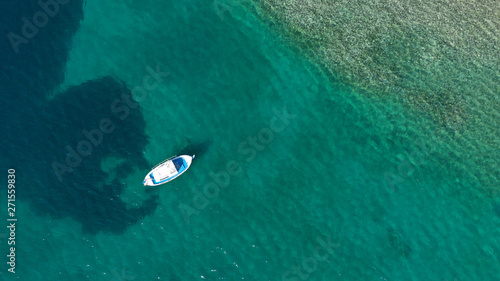 Aerial drone bird's eye top view photo of traditional fishing boats in island of Mykonos, Cyclades, Greece