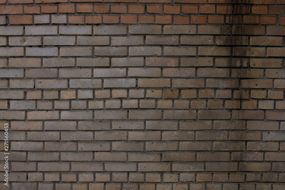 old brick wall of light brown brick
