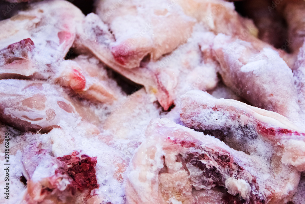 Frozen raw chicken, background macro view from above