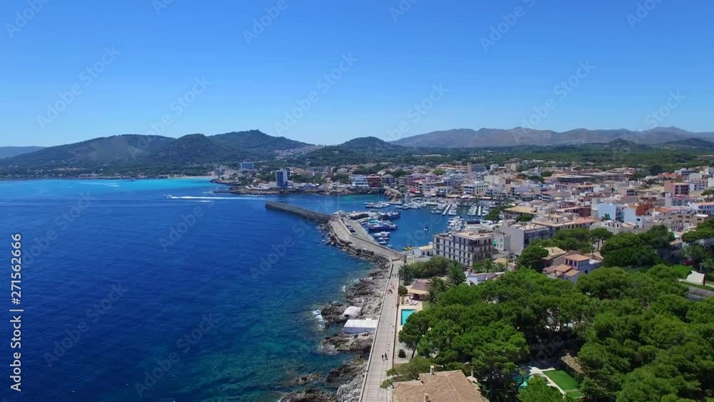 Drone shot flying towards the port of Cala Ratjada on Mallorca. Beautiful, sunny and hot day in the middle of a summer. Drone shot flying towards the port of Cala Ratjada on Mallorca. Beautiful, sunny and hot day in the middle of a summer.