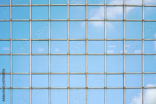 Glass blue Windows of facade modern city business building skyscraper. Modern apartment buildings in new neighborhood. Windows of a building, texture.