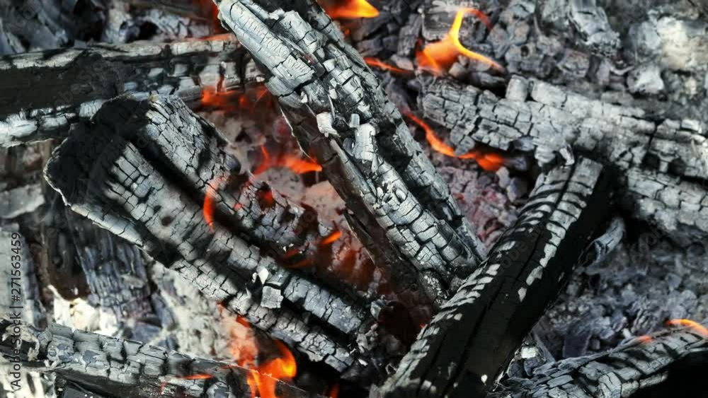 Close-up of firewood burning in the fire, coal and ash, top view Close-up of firewood burning in the fire, coal and ash, top view