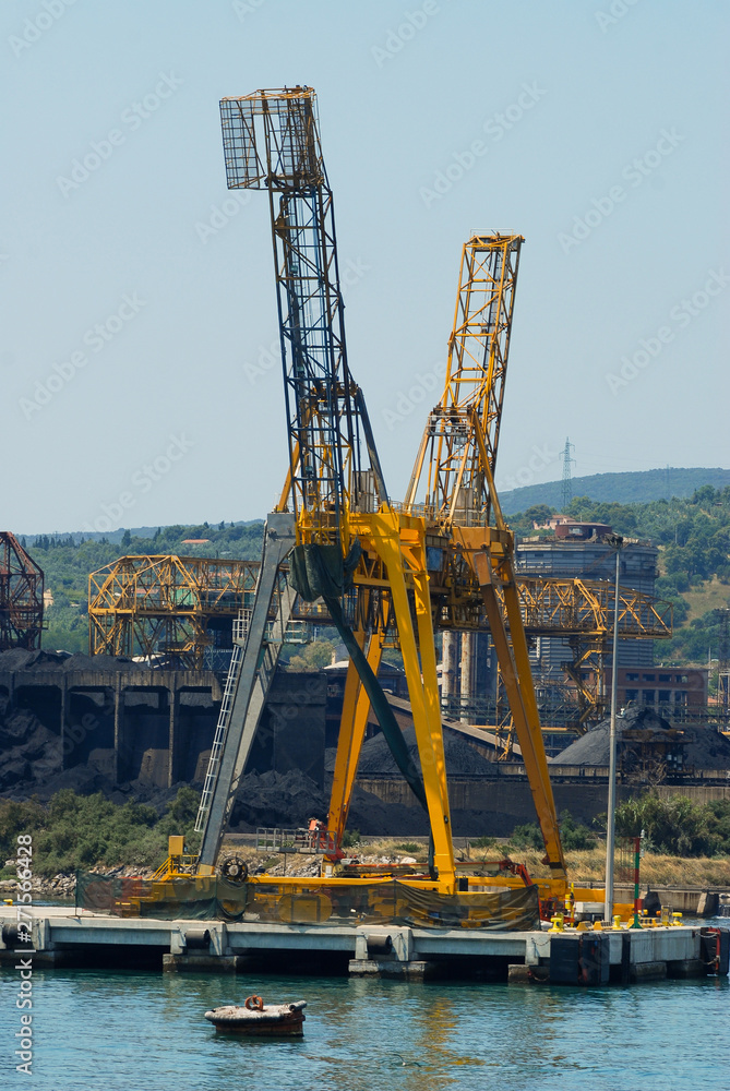 Fototapeta premium The port of Piombino with coal deposits and an industry that produces steel