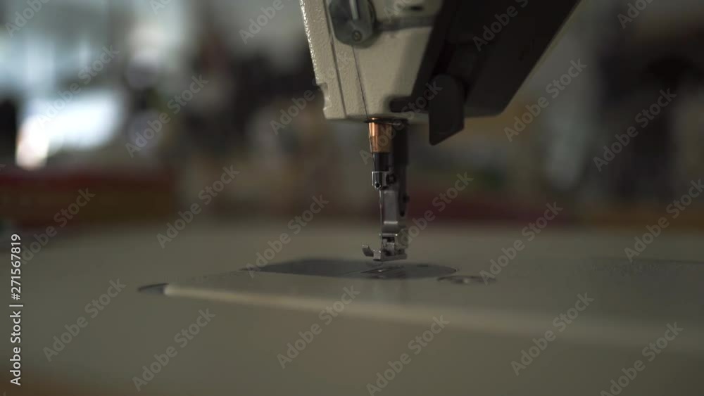 Sewing machine niddle close up with bokeh creamy background Sewing machine niddle close up with bokeh creamy background