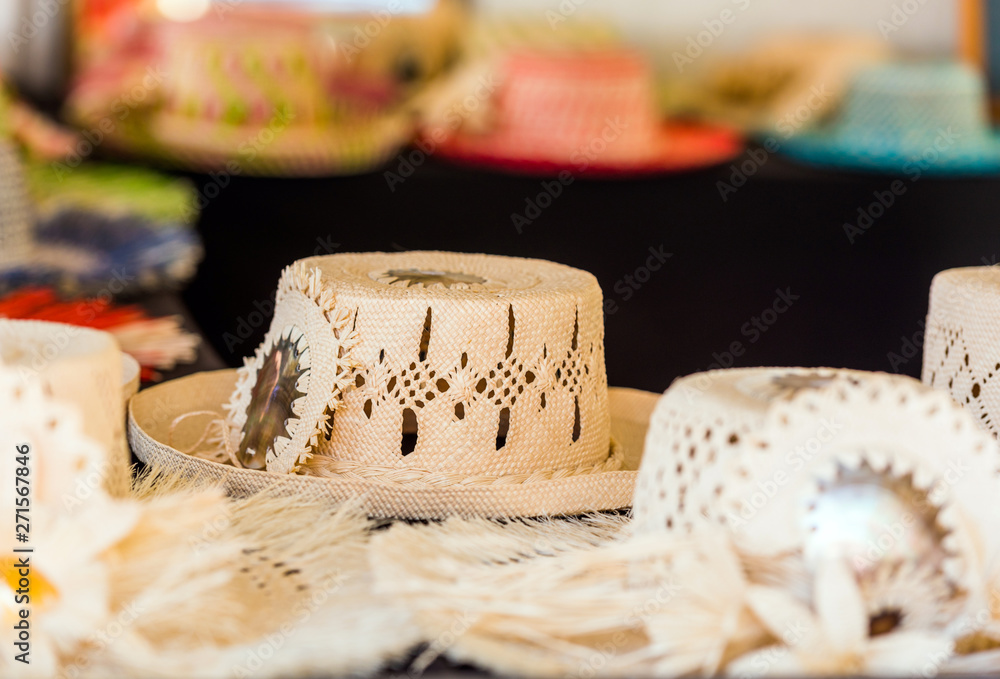 Straw hats for sale in a tropical souvenir shop in Aitutaki, Cook Islands.  With selective focus. Stock Photo | Adobe Stock