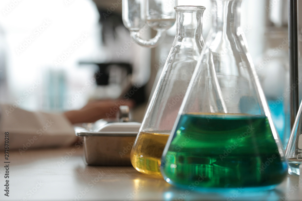 green and yellow solutions in beaker green and yellow solutions in beaker