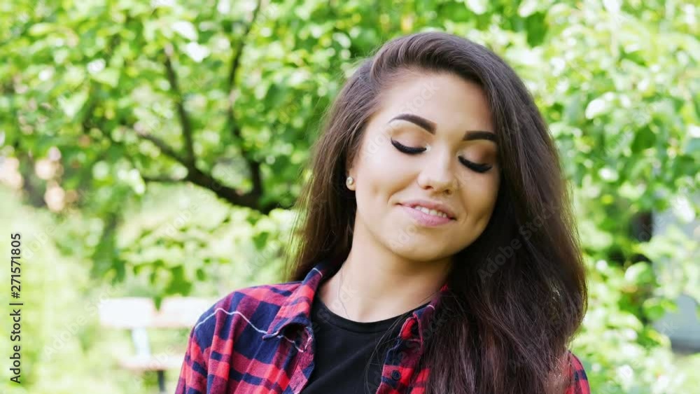 Beautiful young agrarian woman enjoying nature in summer garden, happy girl smiling and looking at the camera. Beautiful young agrarian woman enjoying nature in summer garden, happy girl smiling and looking at the camera.