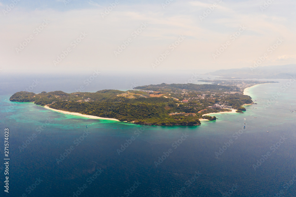 Seascape with island of Boracay, Philippines, top view. A large island with urban buildings and white beaches.