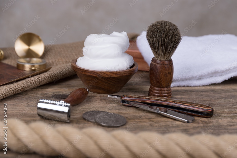 vintage shaving accessories - wooden razor with shaving brush and shaving  foam on a rustic wooden table Stock Photo | Adobe Stock