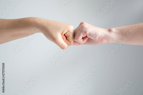 Hand symbol of two fists crash together on white background.