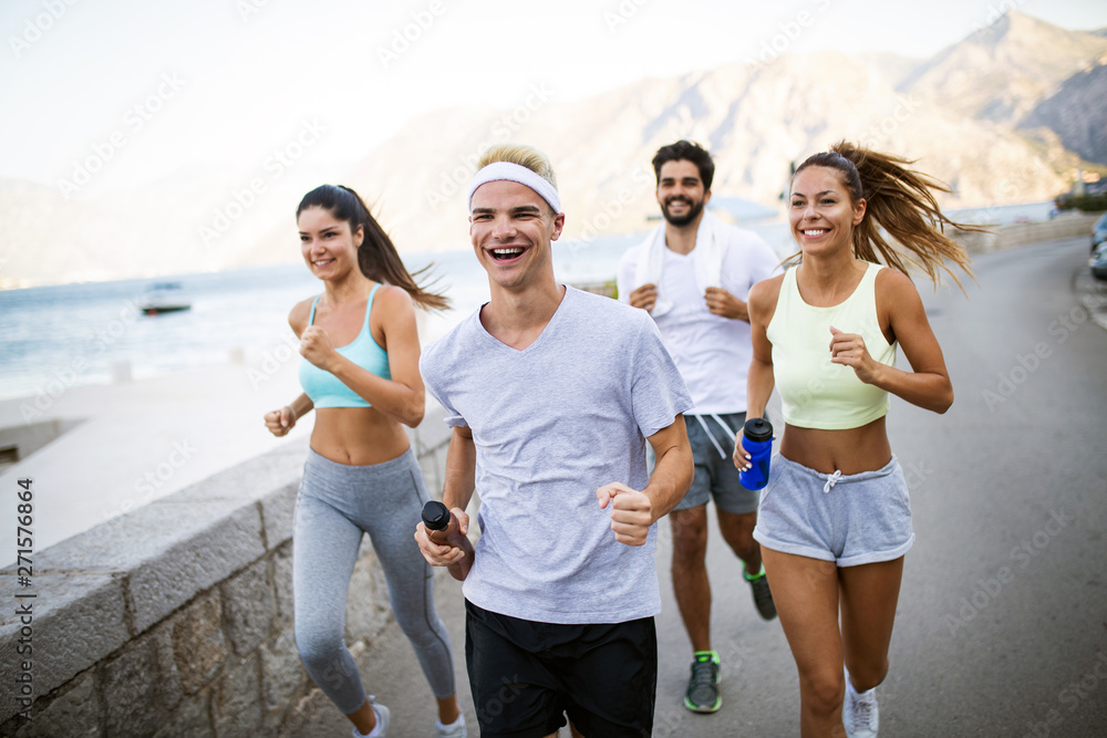 Group of young people friends running outdoors at seaside Group of young people friends running outdoors at seaside