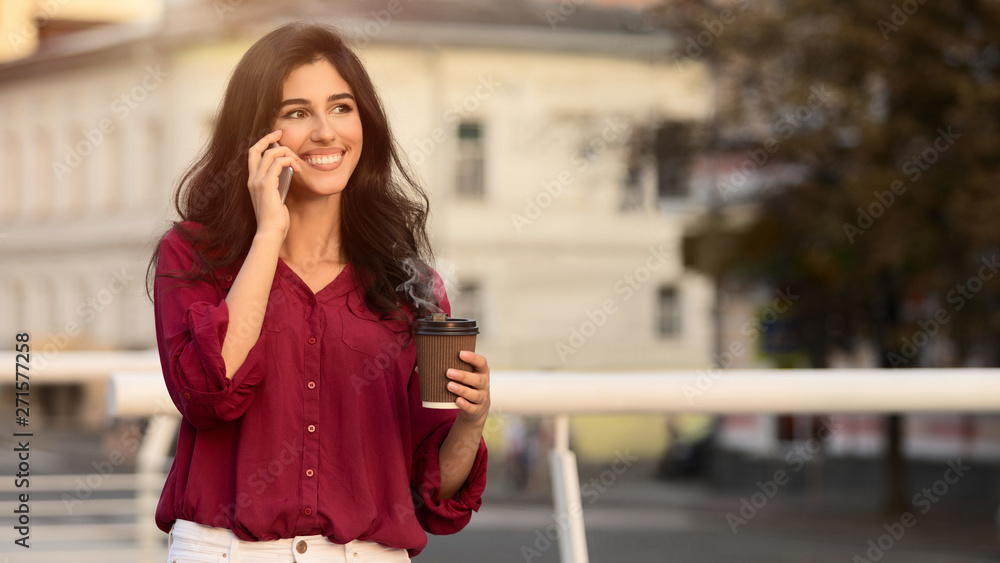 Young manager having break, drinking coffee and talking on phone Young manager having break, drinking coffee and talking on phone