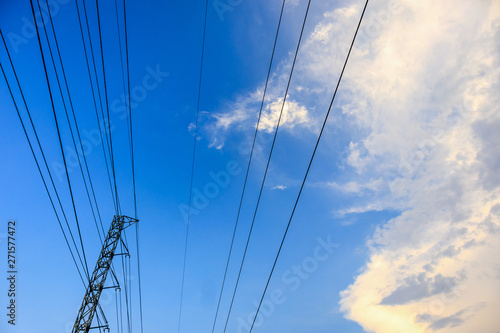 High voltage towers electric lines with clouds and sky