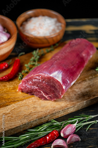 Raw meat in chef hands on black background. Food menu concept.