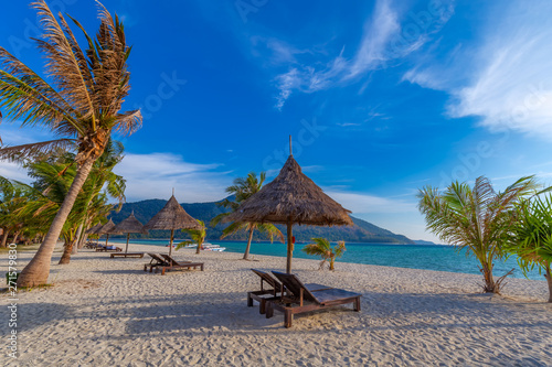 Beach chairs, umbrella and palms on the beautiful beach for holidays and relaxation at Koh Lipe island, Thailand © rbk365