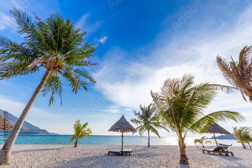 Beach chairs  umbrella and palms on the beautiful beach for holidays and relaxation at Koh Lipe island  Thailand