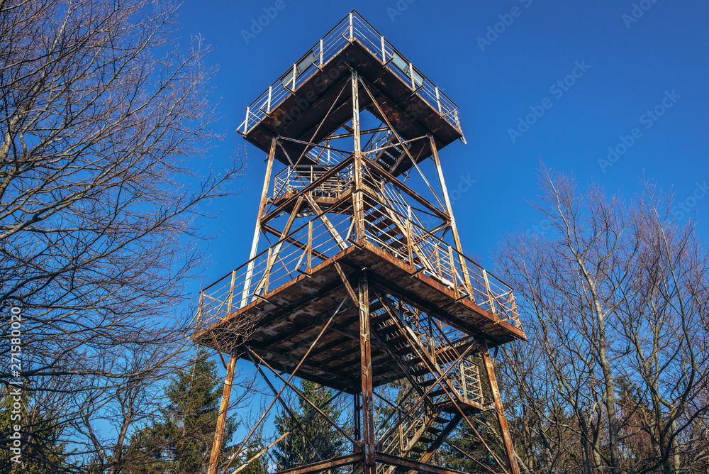 Old rusty observation tower on the peak of Mount Kalenica in Owl Mountains Landscape Park, protected area in Lower Silesia Province of Poland Old rusty observation tower on the peak of Mount Kalenica in Owl Mountains Landscape Park, protected area in Lower Silesia Province of Poland
