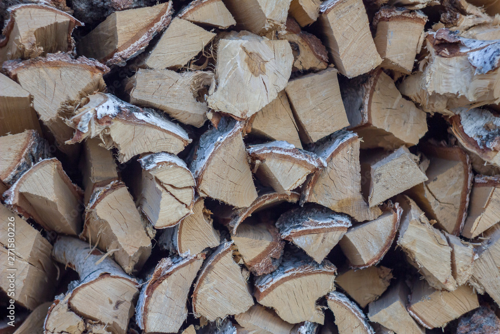 chopped dry gray birch firewood close-up lie in a heap in rows. natural surface texture chopped dry gray birch firewood close-up lie in a heap in rows. natural surface texture
