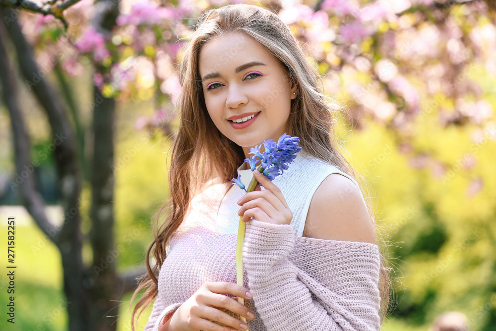 Beautiful young woman with hyacinth flowers outdoors Beautiful young woman with hyacinth flowers outdoors