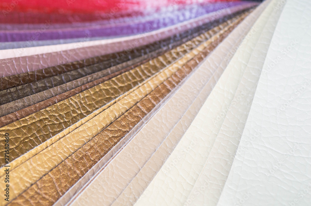 Fototapeta premium Catalog of multicolored imitation leather from matting fabric texture background, leatherette fabric texture. Industry background. 