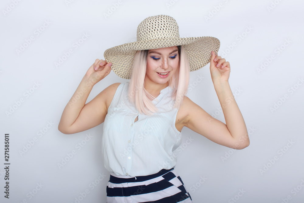 Young blonde woman with big white summer hat Young blonde woman with big white summer hat