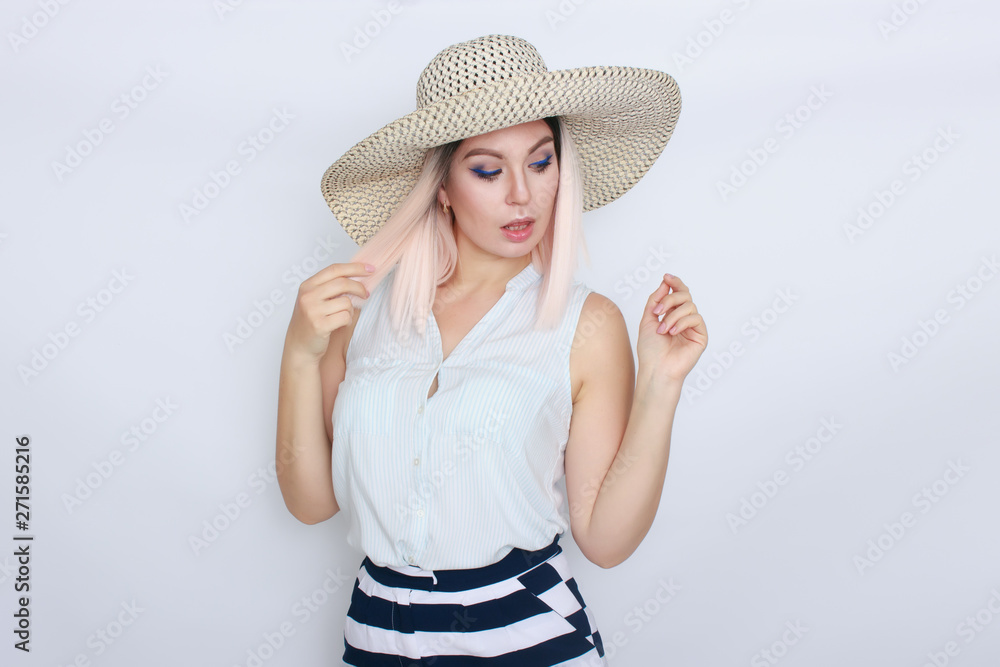 Young blonde woman with big white summer hat Young blonde woman with big white summer hat
