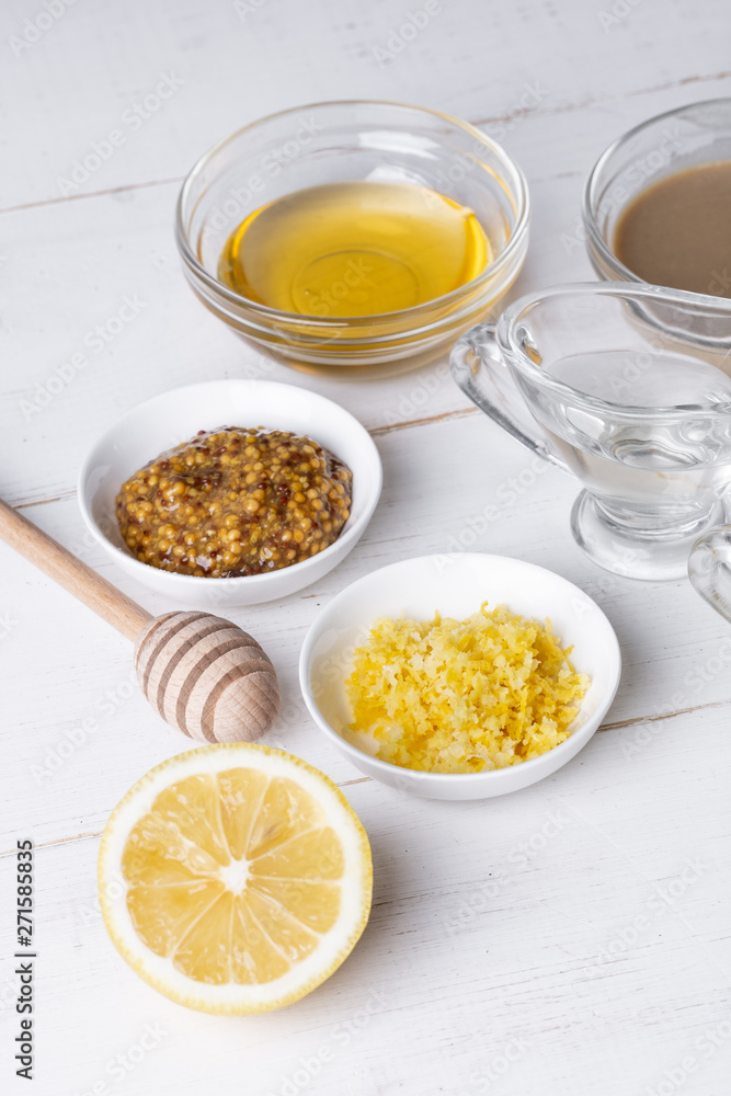 Ingredients for cooking traditional mustard sauce on white wooden background. Food concept Ingredients for cooking traditional mustard sauce on white wooden background. Food concept