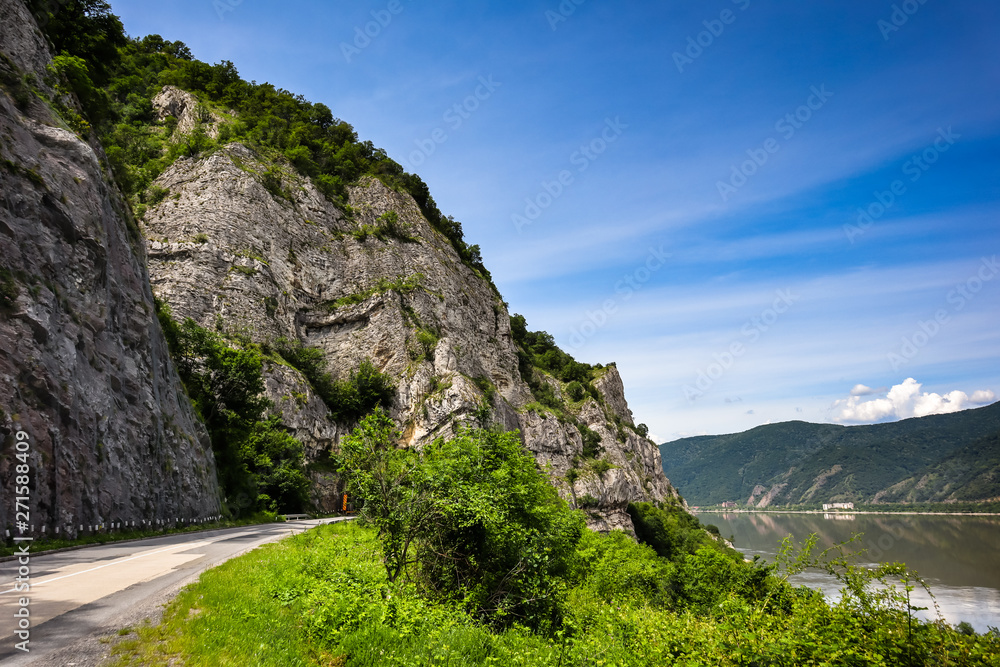 Road by the Danube river, forests and mountains in Djerdap gorge national park in Serbia