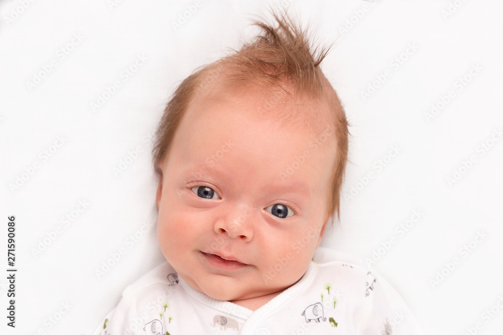 Cute Smiling newborn baby boy. Adorable infant looking at camera. Cute Smiling newborn baby boy. Adorable infant looking at camera.