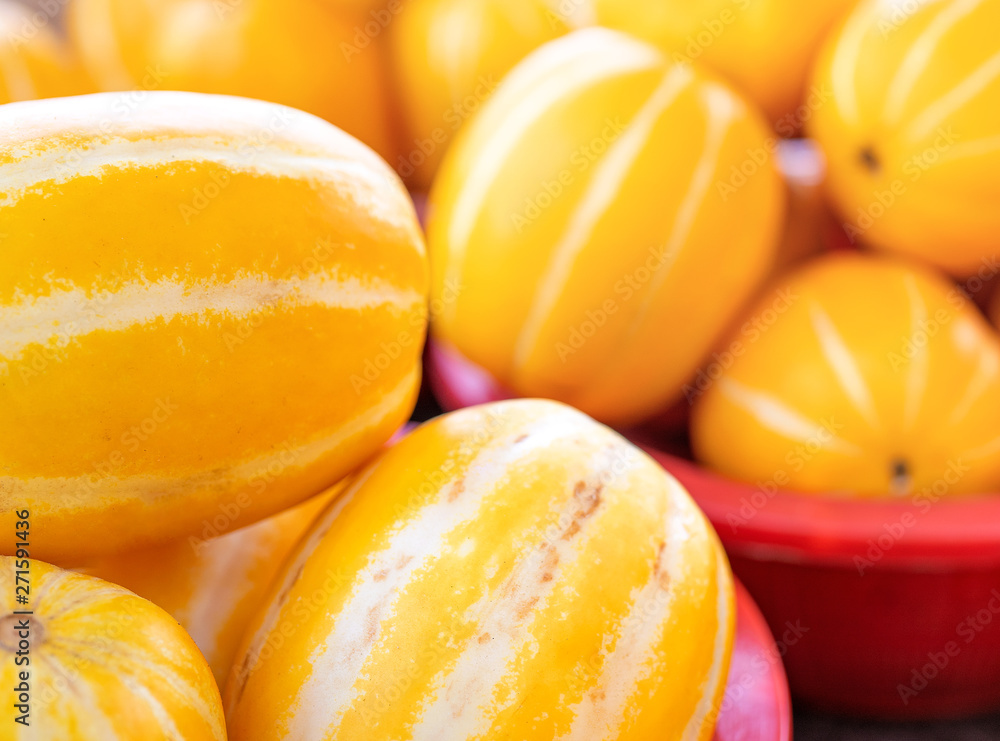 Delicious korean stripe yellow melon fruit food in red plastic basket at tradition market afternoon, Seoul, South Korea, harvest concept, close up. Delicious korean stripe yellow melon fruit food in red plastic basket at tradition market afternoon, Seoul, South Korea, harvest concept, close up.