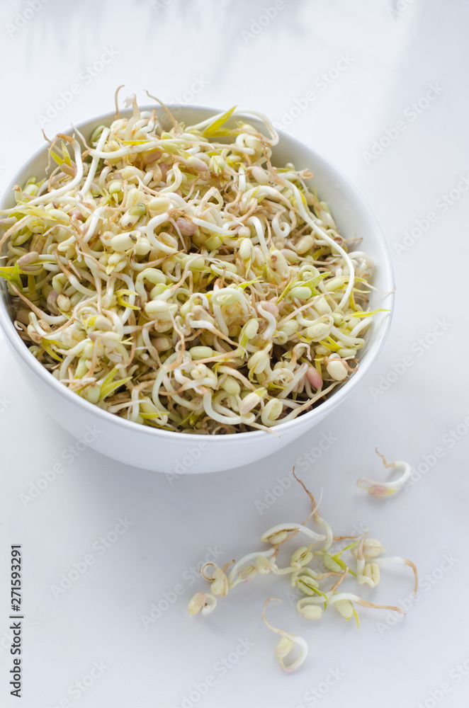 mung beans on white background, in a white deep plate