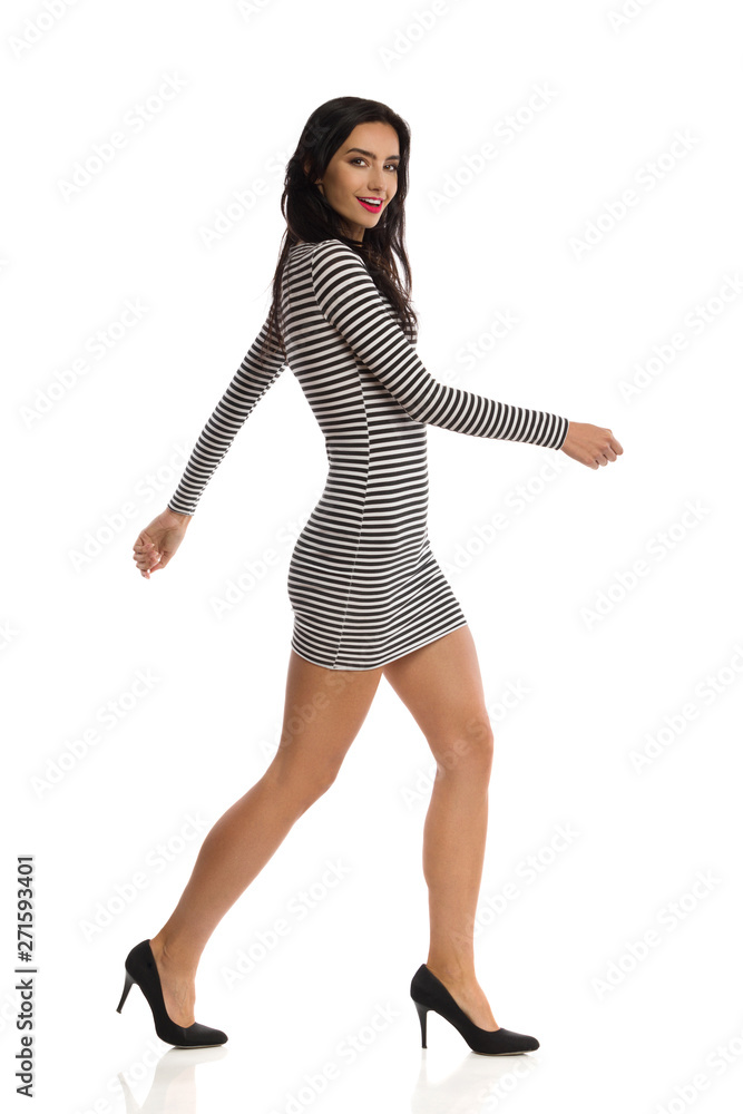 Happy Young Woman Is Walking In High Heels And Striped Mini Dress And  Talking Stock-Foto | Adobe Stock