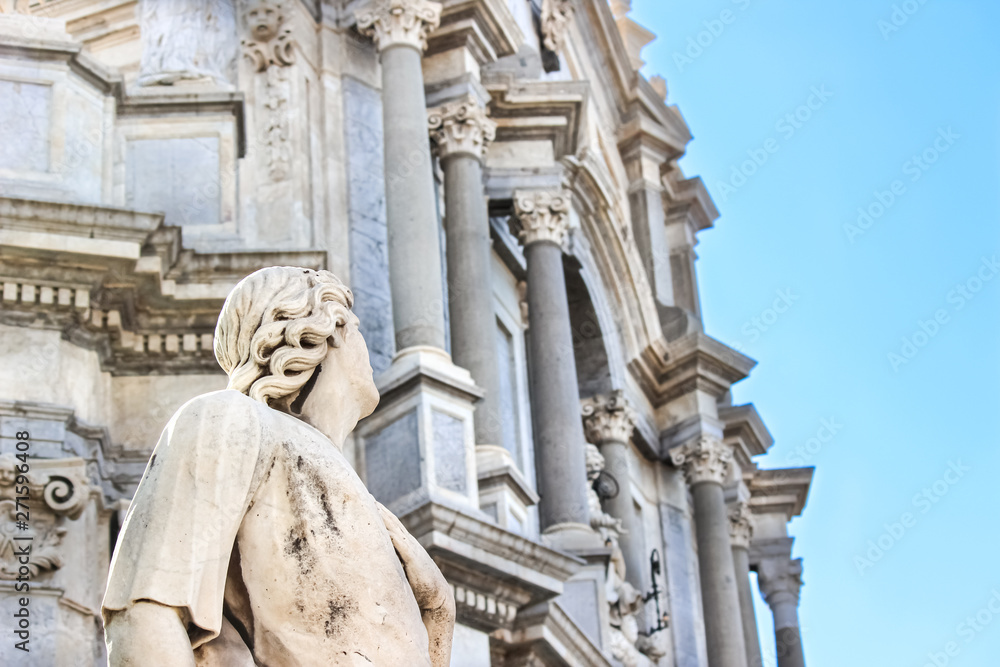 Beautiful detail of Antique statue on Catania Cathedral with blurred Roman Catholic shrine in the background. The Baroque Duomo is one of major sights in Catania, Sicily, Italy