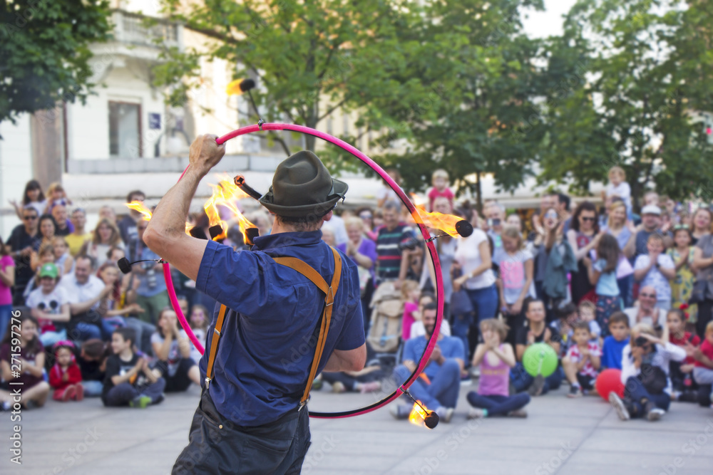 Fototapeta premium Street performer with a fire wheel