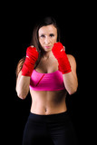 Terrible girl in a fighting stance boxer. concept of female martial arts. defense and self-defense. feminism. red fists. black background.