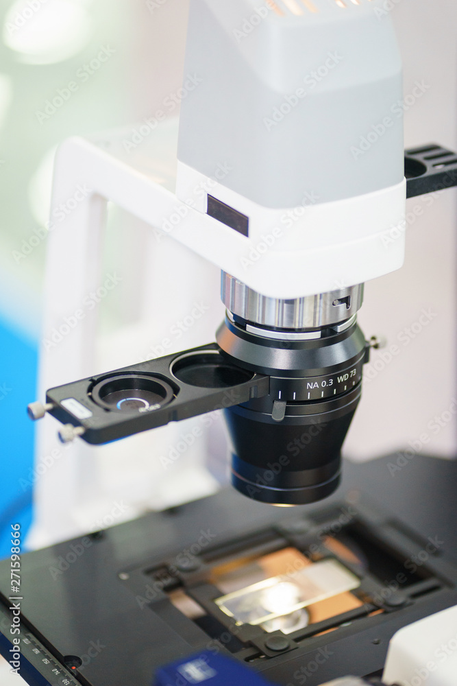 Close up modern medical instrument microscope for the study of biological samples. Close up modern medical instrument microscope for the study of biological samples.