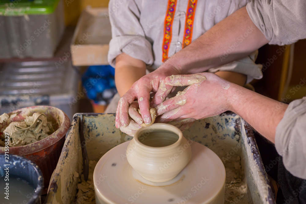 Potter showing how to work with ceramic in pottery studio Potter showing how to work with ceramic in pottery studio