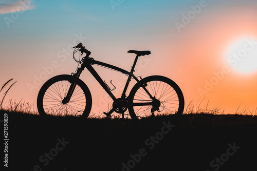 silhouette of a bicycle at sunset. bike without a man.