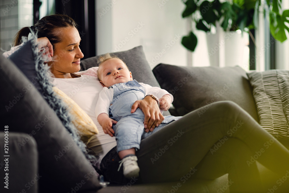 Young smiling woman enjoying in motherhood. Young smiling woman enjoying in motherhood.