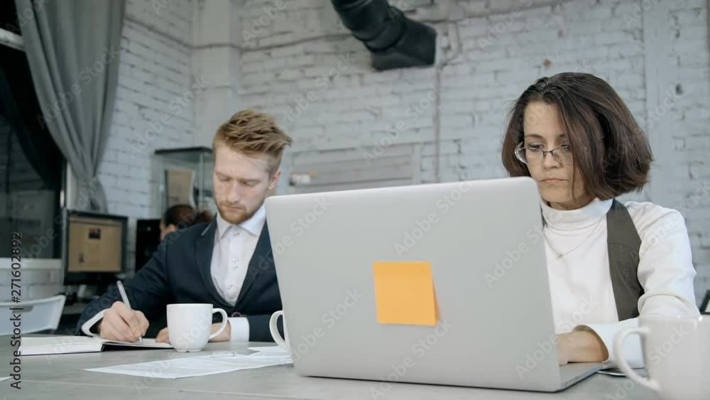 Woman and man using laptop, agenda and working in office Woman and man using laptop, agenda and working in office