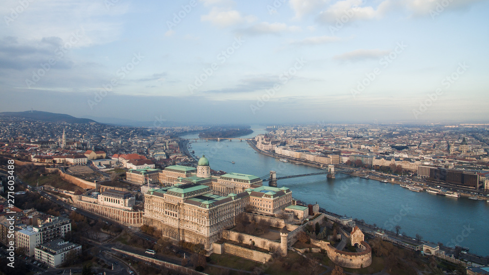 Aerial skyline view of Buda Castle with Szechenyi Chain Bridge and Danube River. Drone over Budapest.