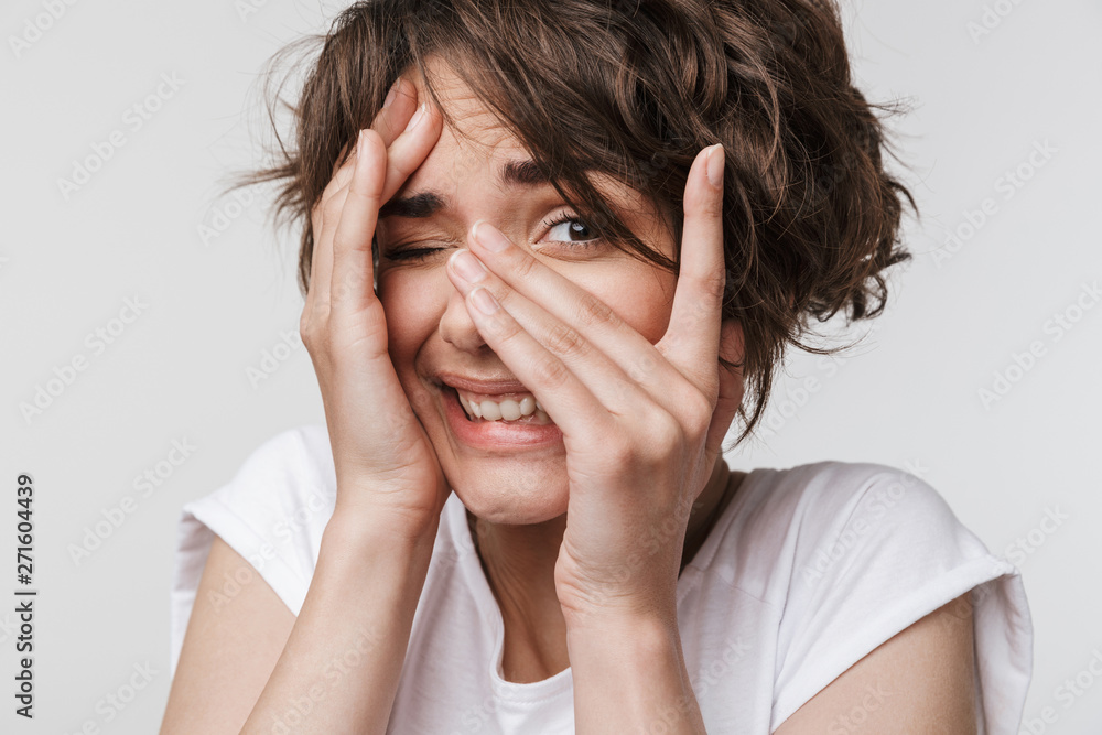Beautiful young pretty scared woman posing isolated over white wall background. Beautiful young pretty scared woman posing isolated over white wall background.