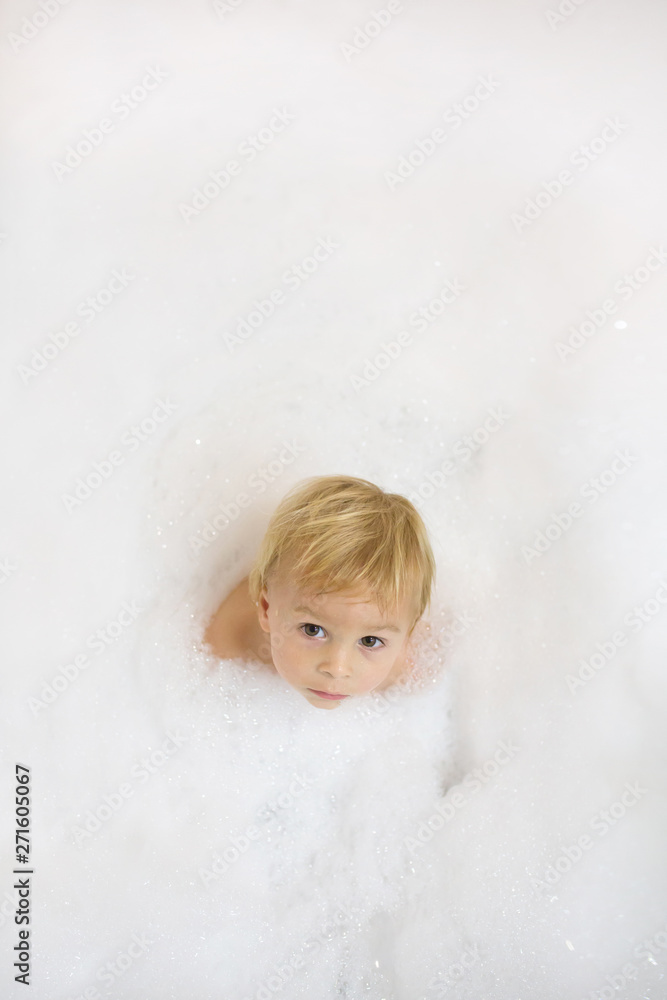 Little boy in the bathroom. Child bathing with a lot of foam Little boy in the bathroom. Child bathing with a lot of foam