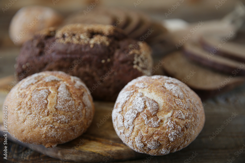  assortment of wheat and rye bread, close-up on a wooden rustic background